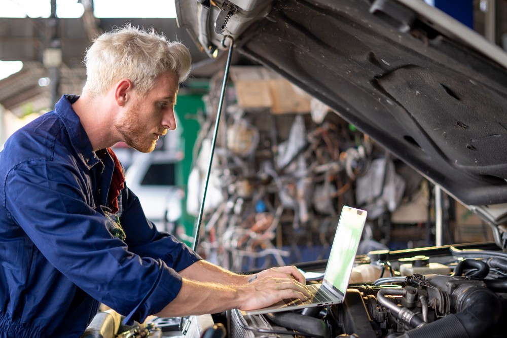 Mechaniker der ein Fahrzeug inspiziert
