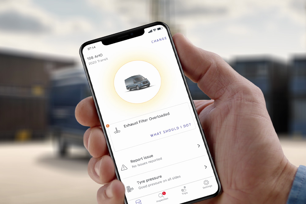 Hand hält ein Smartphone mit geöffneter Ford Telematics Drive App.